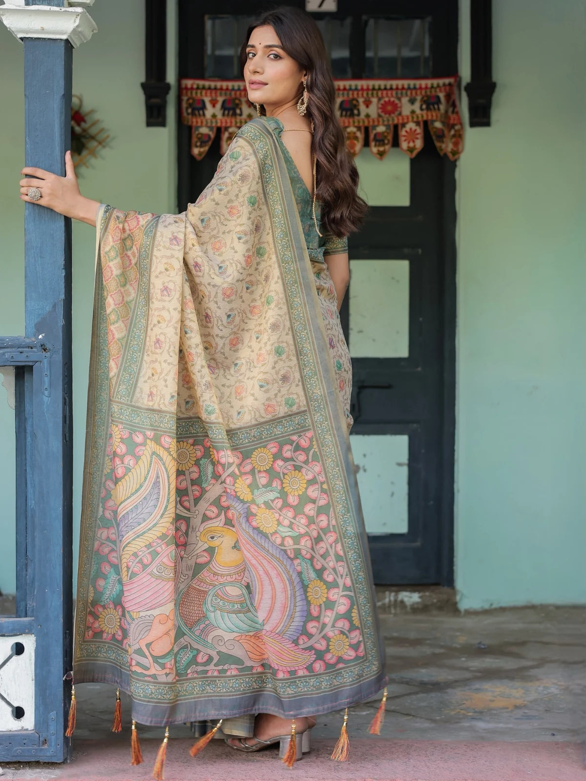 Tarani Vaibhavi premium handloom beige saree back view with artistic pallu floral artwork and tassels