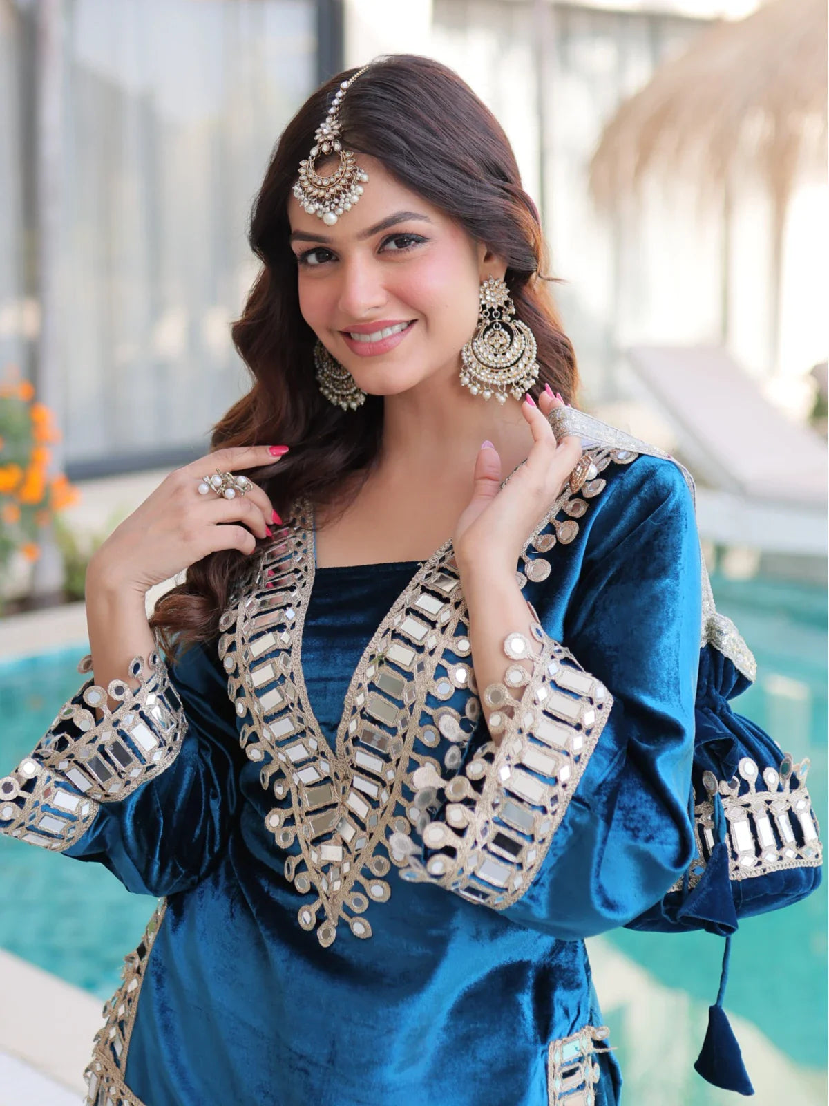 Tarani blue ice velvet festive dress close-up with zari mirror neckline and earrings upper-body-view
