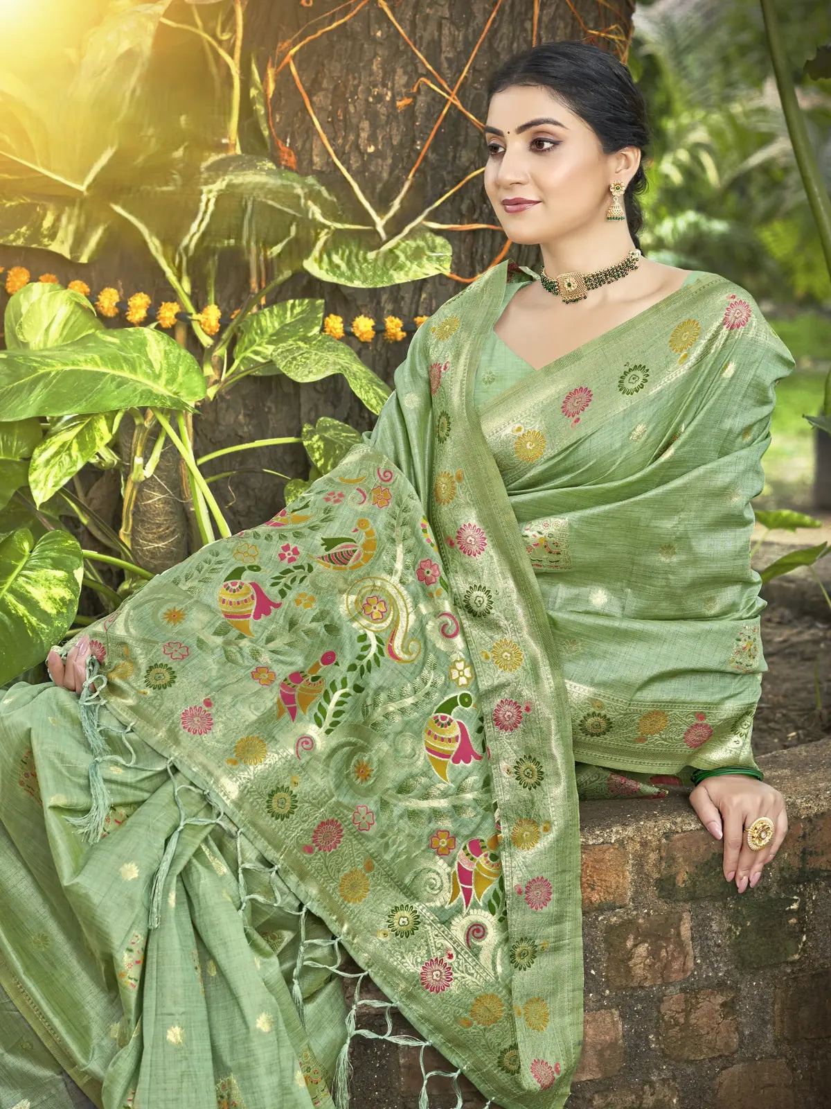 Tarani green Kanan silk saree pallu view with tassels and rich woven bird and floral work