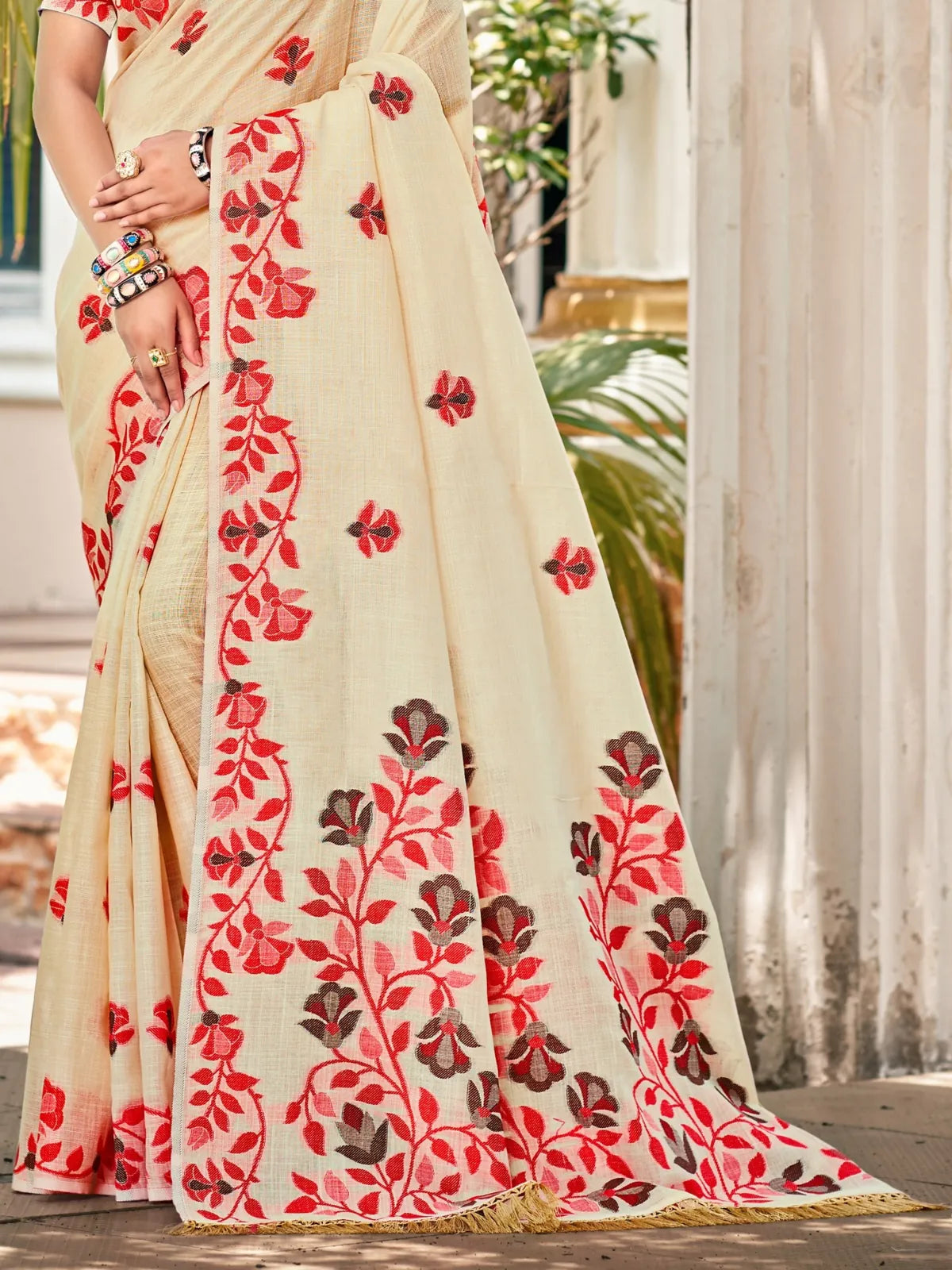 Tarani Lilen saree closeup view highlighting intricate floral embroidery on cream base
