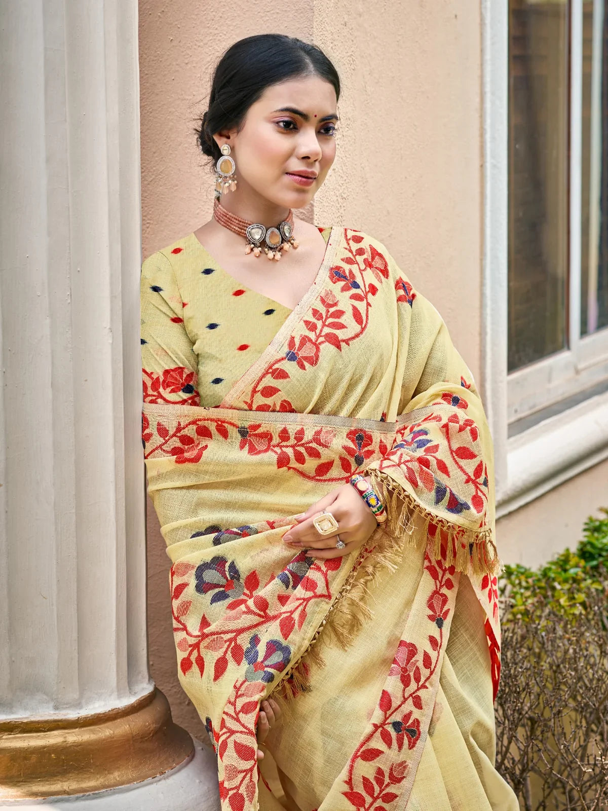 Tarani light yellow Lilen saree upper body view with red floral border and festive design