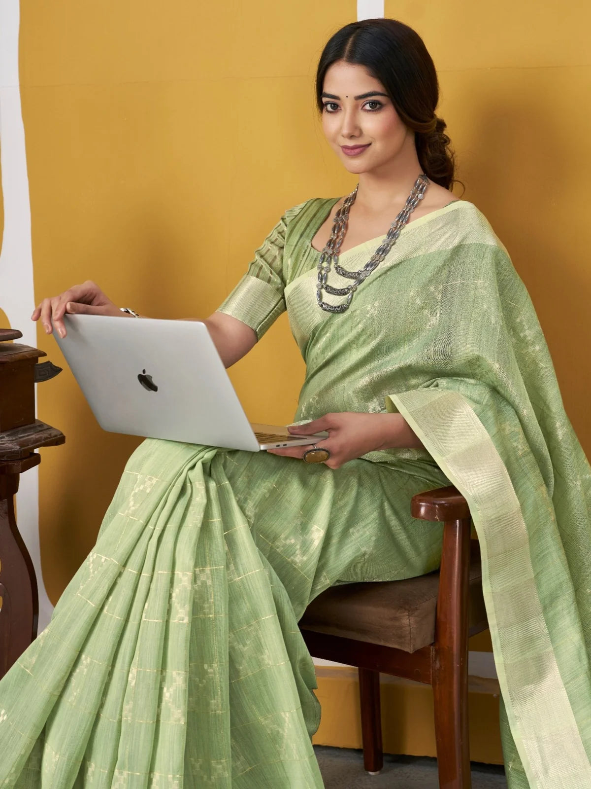 Tarani green party wear saree side pose with zari detailing