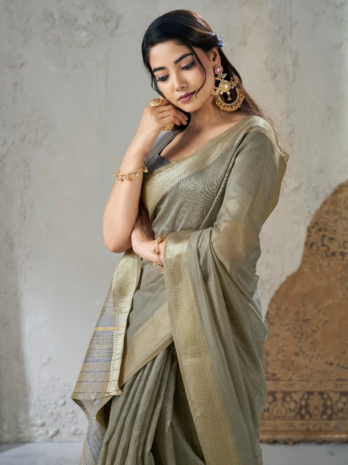 Tarani Neelashri closeup view of olive green linen cotton silk saree zari detailing