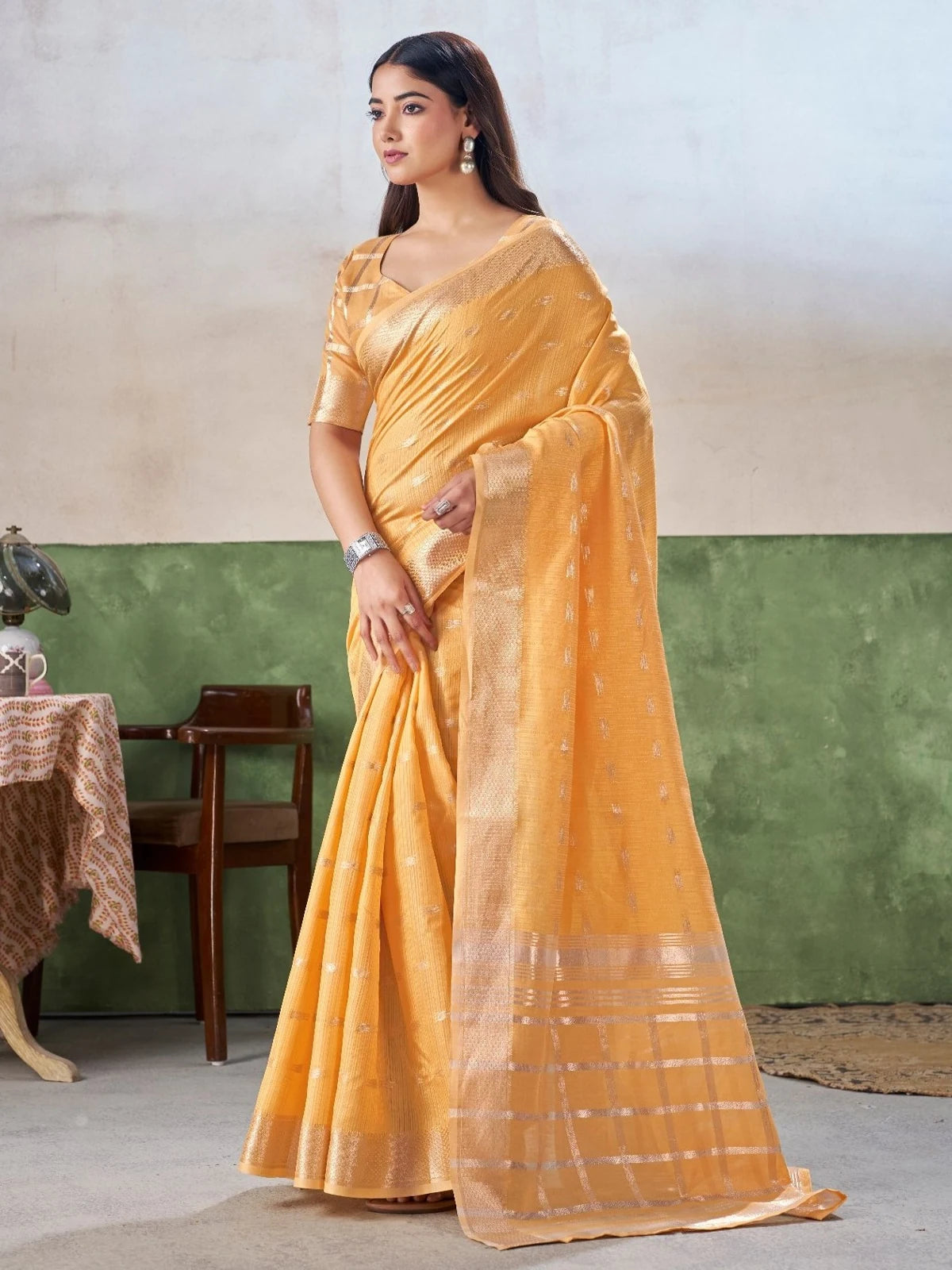 Tarani yellow linen cotton silk saree elegant side pose showcasing woven border and drape