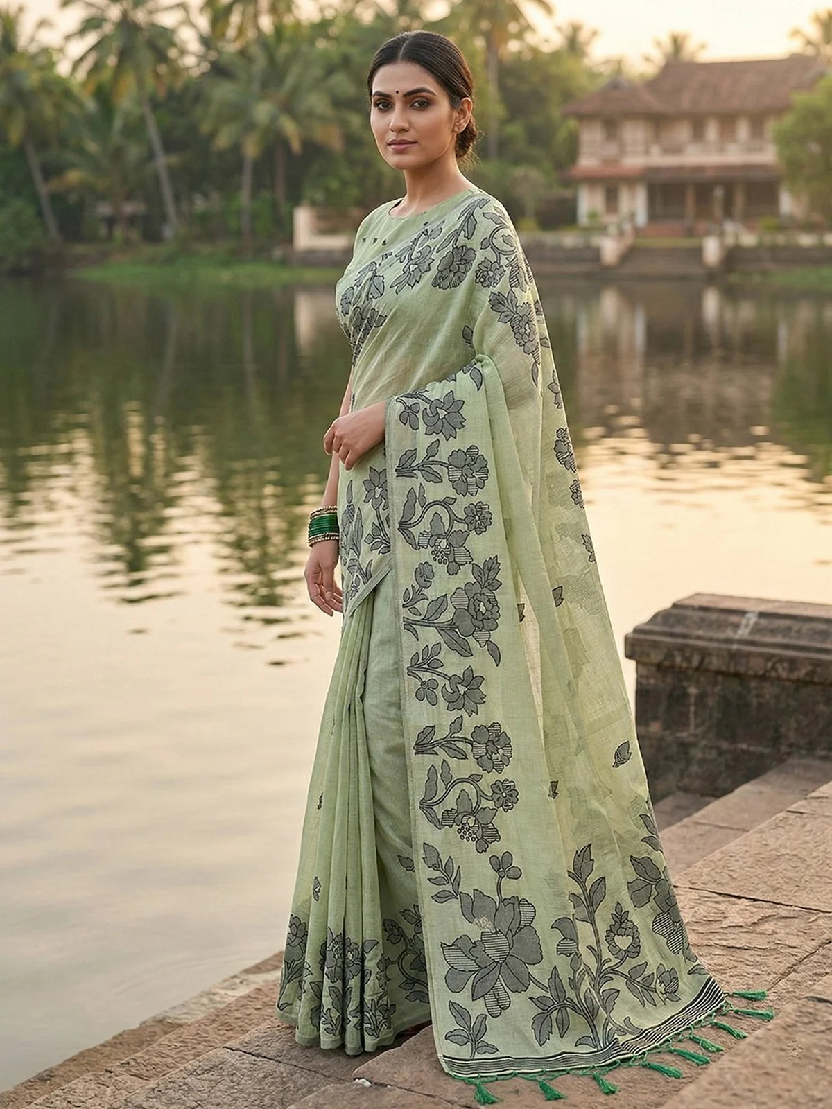 Tarani Gitanjali light green linen cotton saree side view with floral printed pallu and tassels