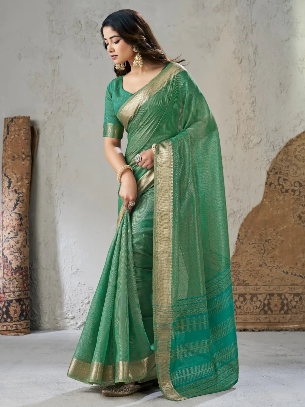 Tarani green linen cotton silk saree side pose showcasing elegant drape and border