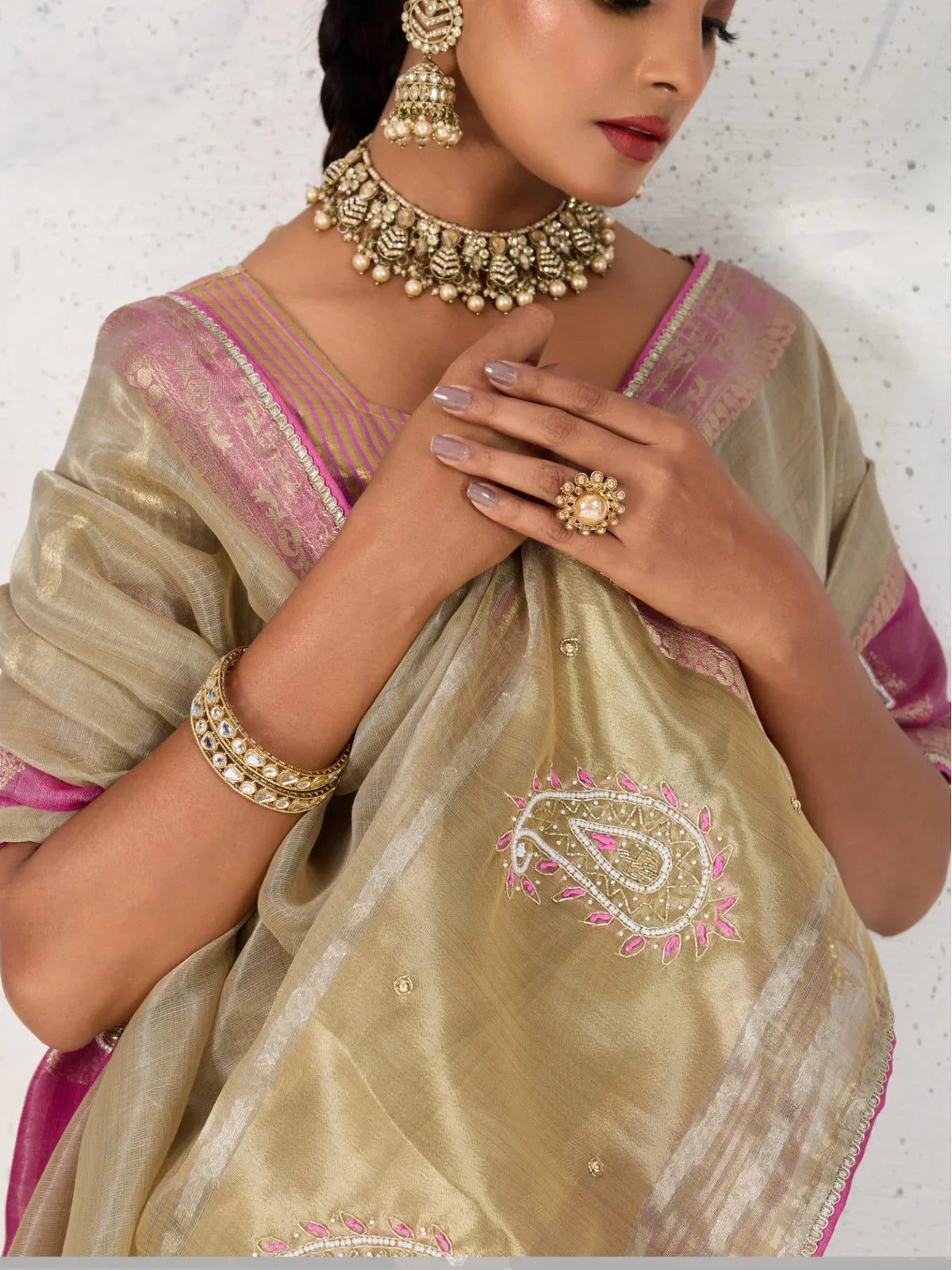 Tarani beige linen saree closeup showing handwork butta with zardosi cutdana and pearls