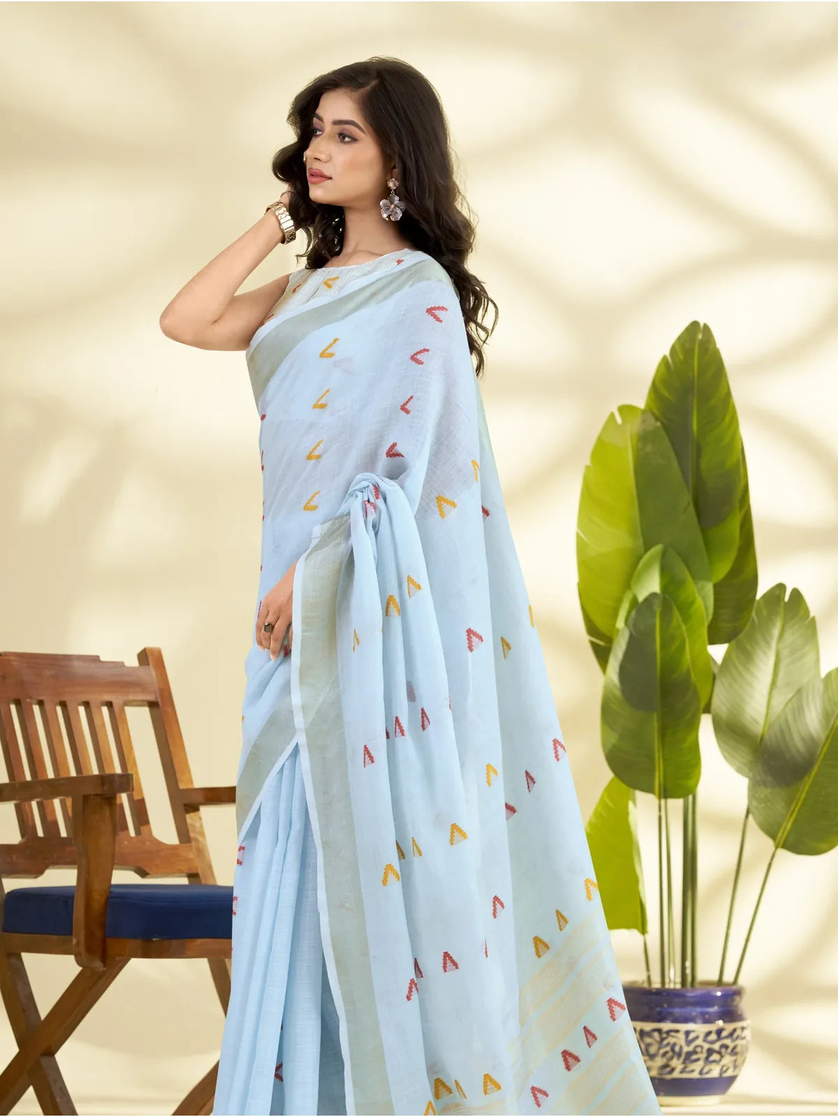 Tarani linen silk saree side view showing soft blue drape with red and yellow chevron motifs