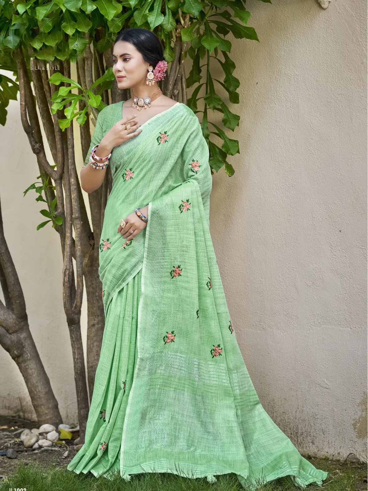 Tarani elegant green linen saree full view with floral embroidery and matching blouse