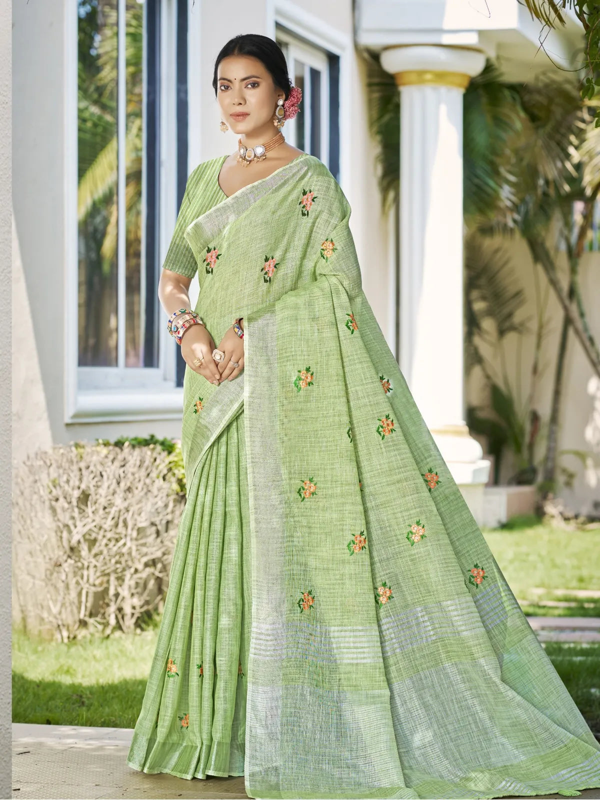 Tarani premium green linen saree with embroidery shown in full view with blouse piece