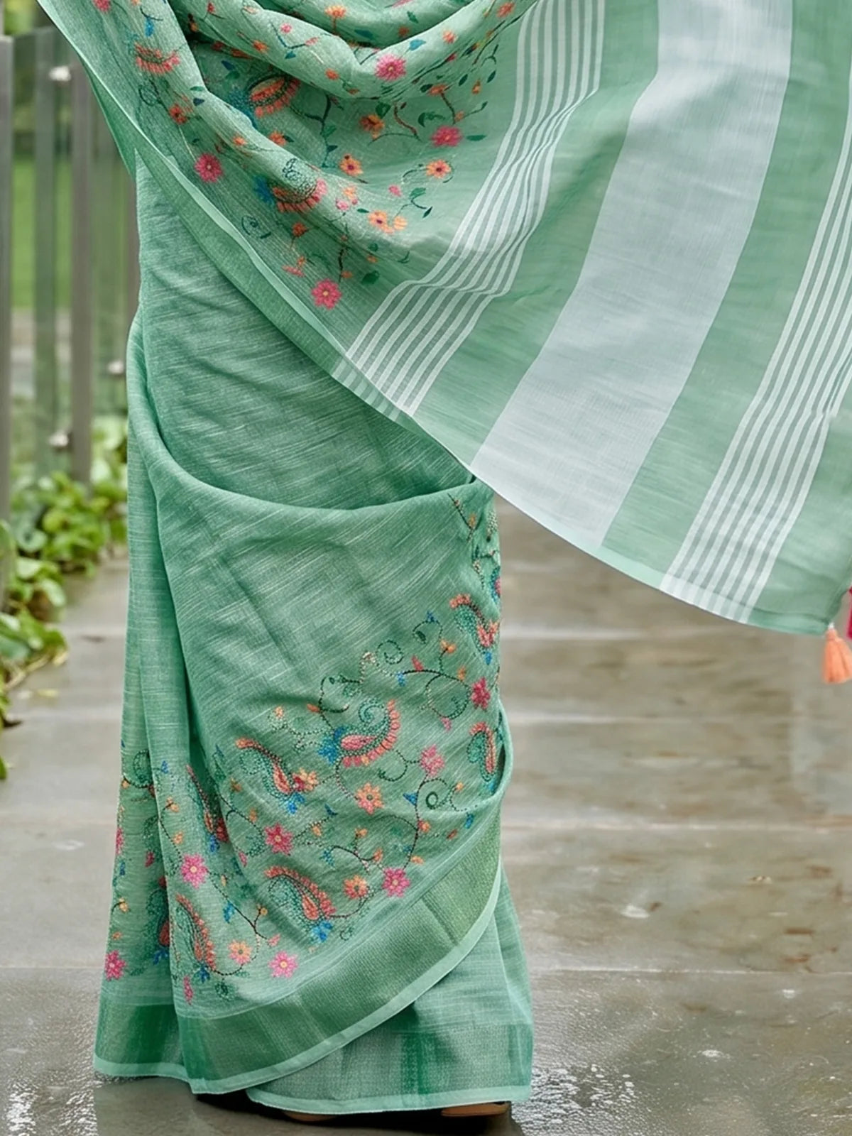 Tarani green linen saree pallu close view with striped border and tassels