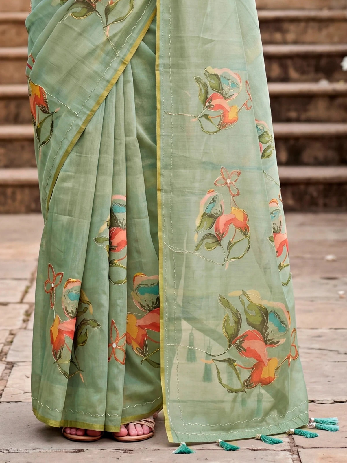 Tarani sage green linen cotton saree pallu view with floral motifs Aari work and border detailing
