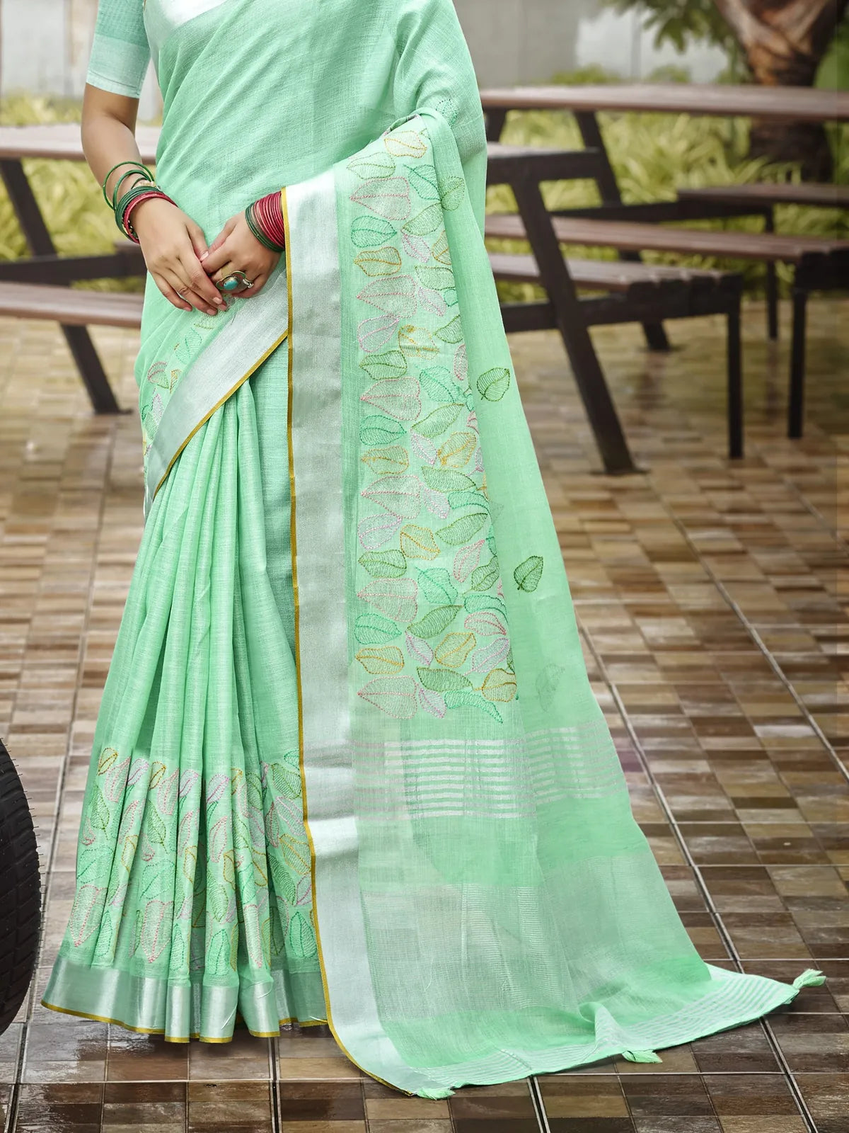 Tarani green linen saree with embroidered pallu and leaf motifs detailed view