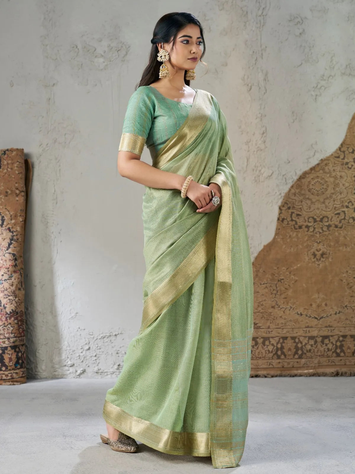Tarani Parinita green zari work saree elegant side view with rich woven border