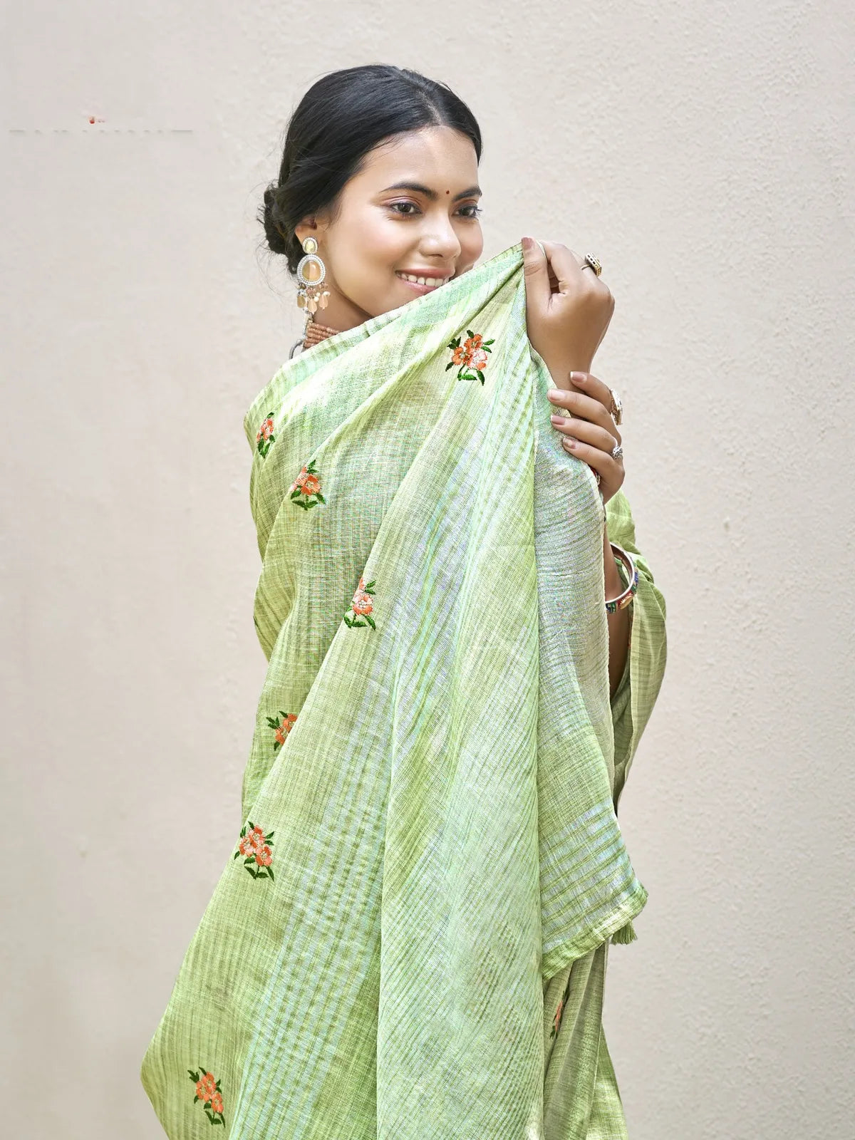Tarani elegant green linen saree upper body view with floral embroidery and matching blouse