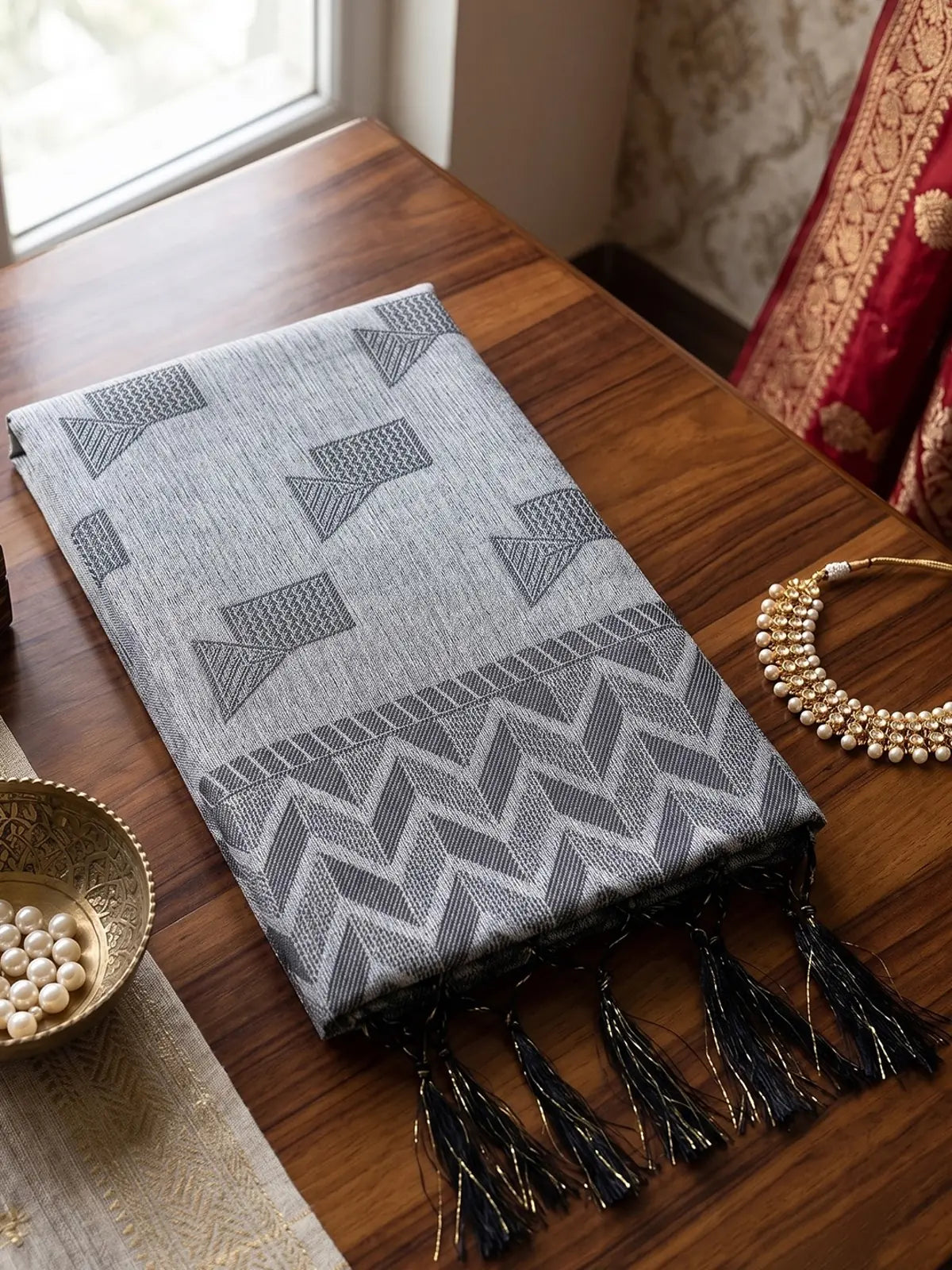Tarani grey linen cotton saree closeup showing woven geometric pattern and tassel