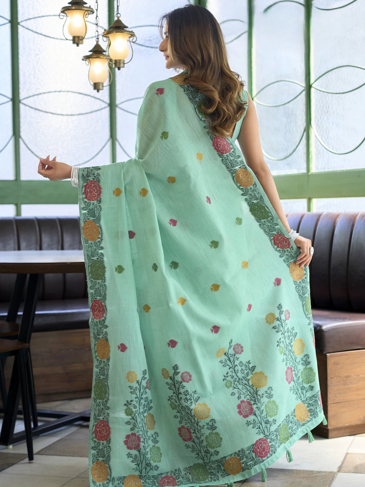 Tarani mint green floral woven linen saree elegant back view with detailed pallu