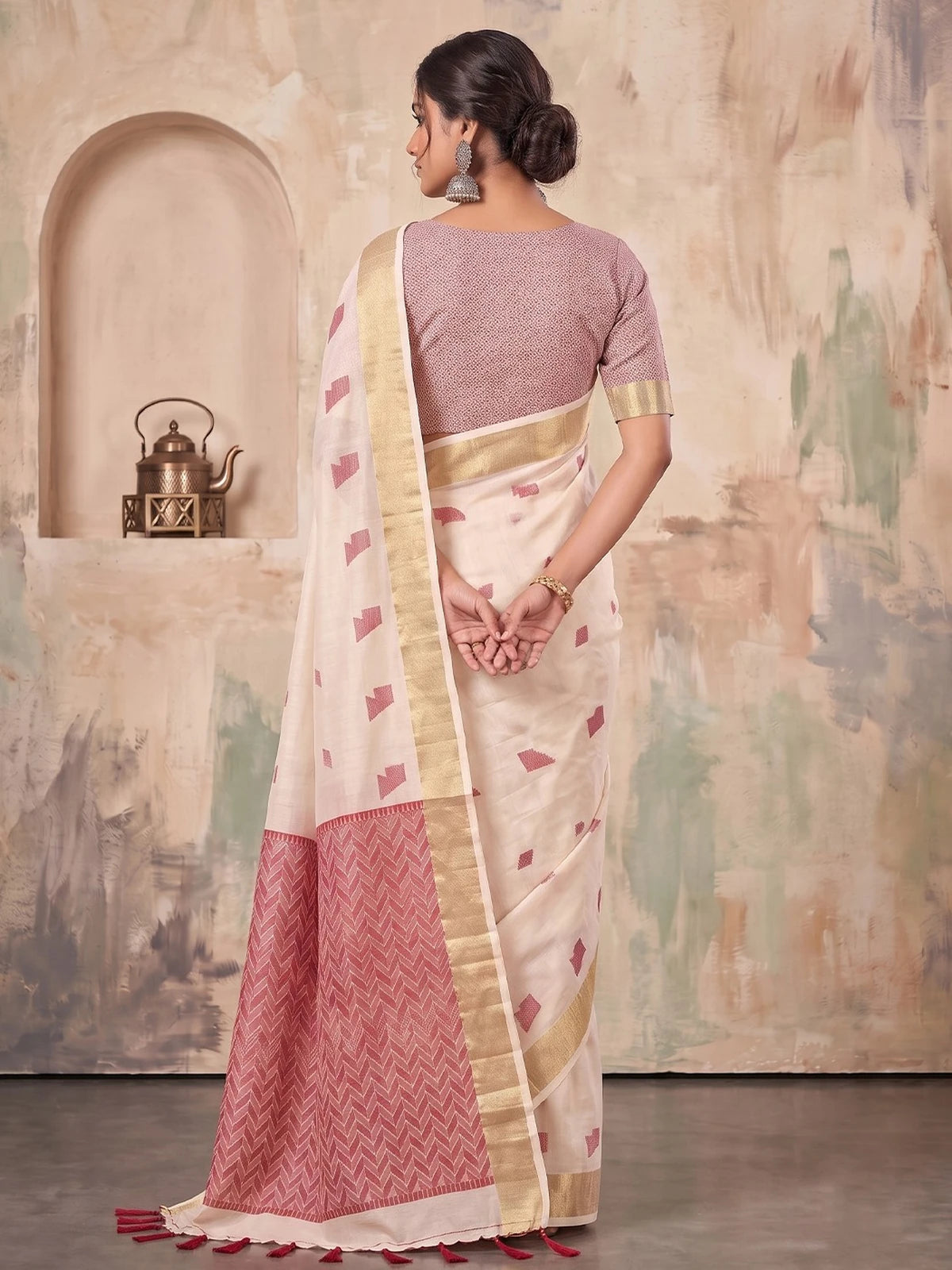 Tarani off white linen cotton saree with geometric woven work and tassels back view