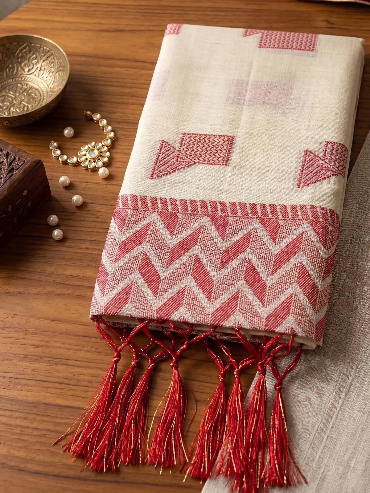 Tarani off white linen cotton saree closeup showing woven border and tassels