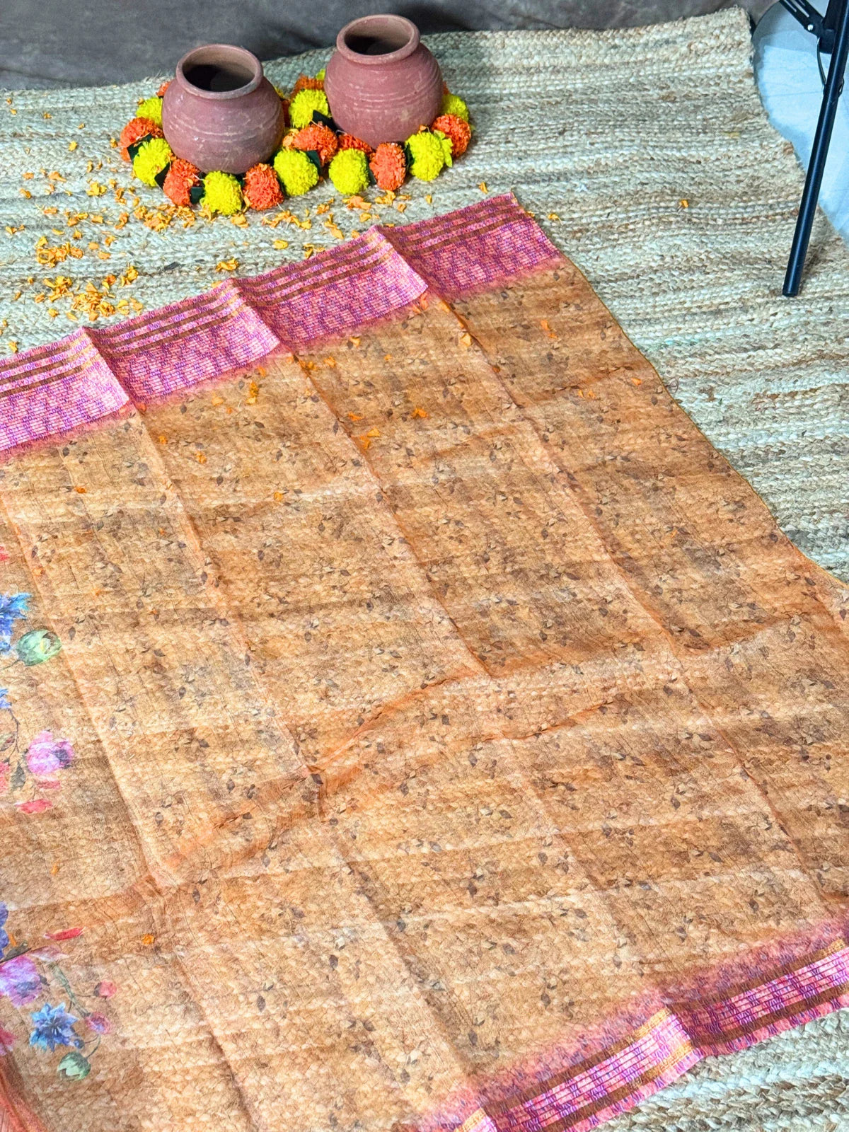 Tarani orange silk saree pallu view showing floral woven detailing by Tarani