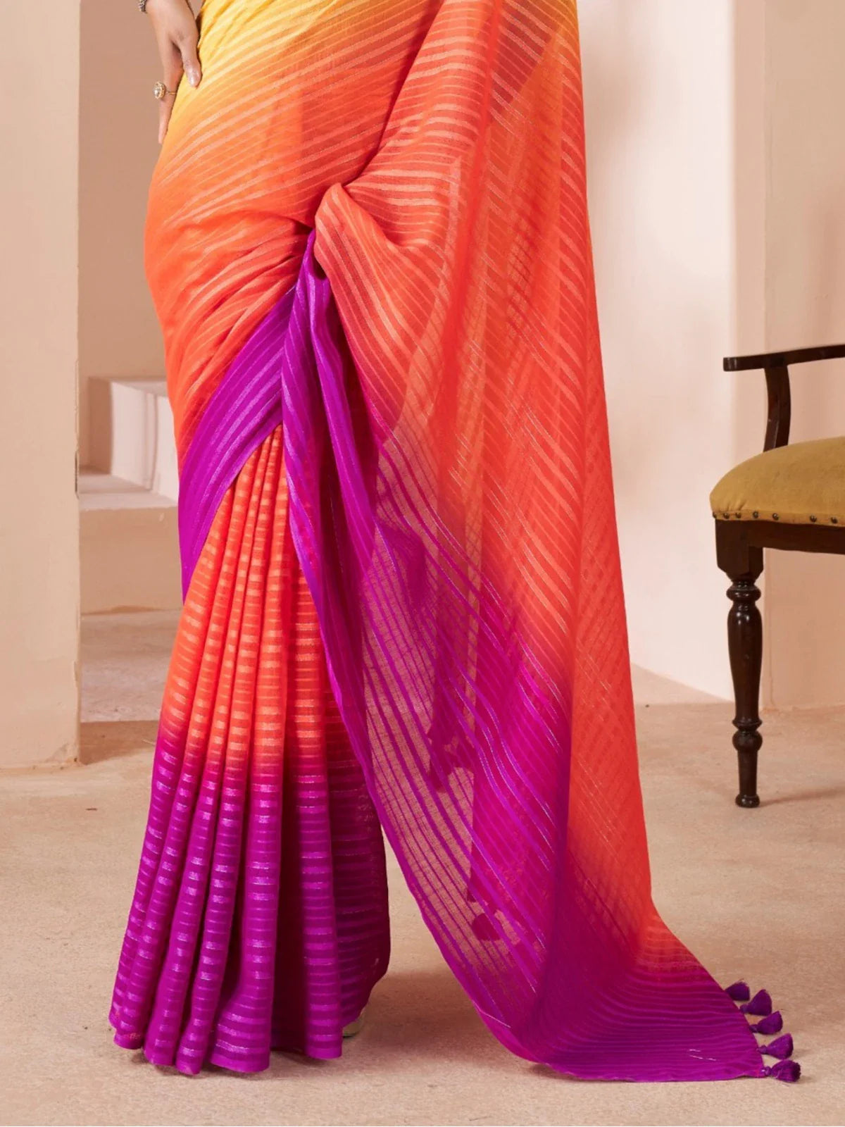 Tarani orange linen saree pallu view highlighting festive tones and texture