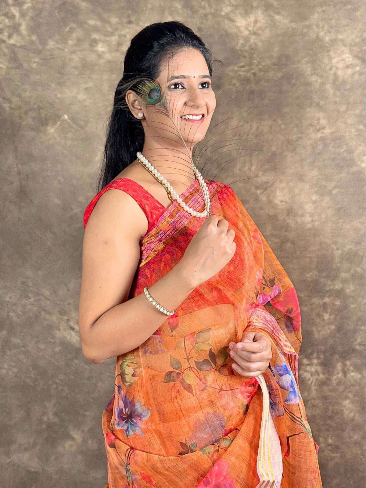 Tarani premium orange silk saree upper body view with floral design and blouse piece