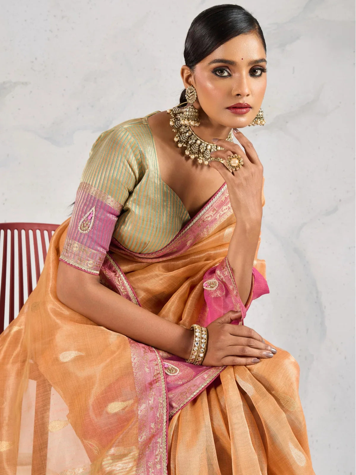 Tarani elegant orange linen saree upper body view with contrast blouse and handwork butti sleeves