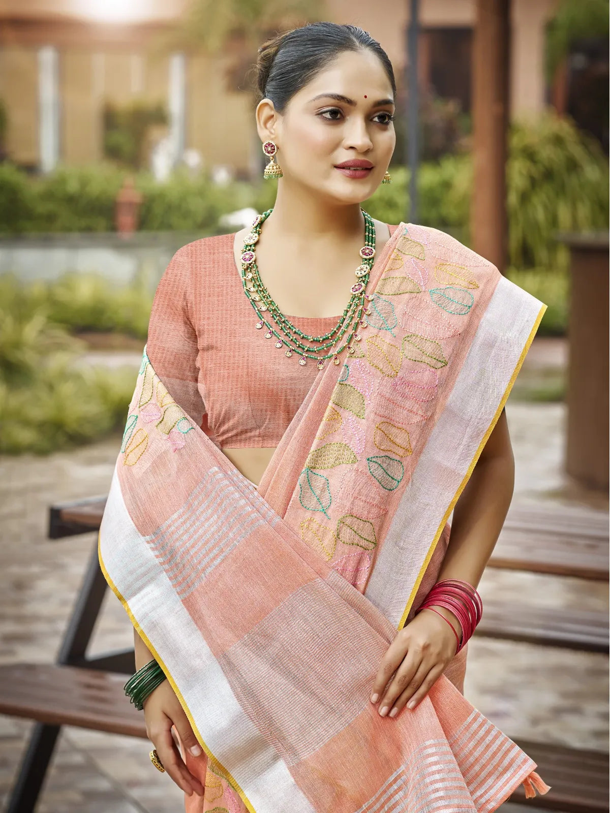 Tarani peach linen saree upper body view with elegant pallu and jewelry styling