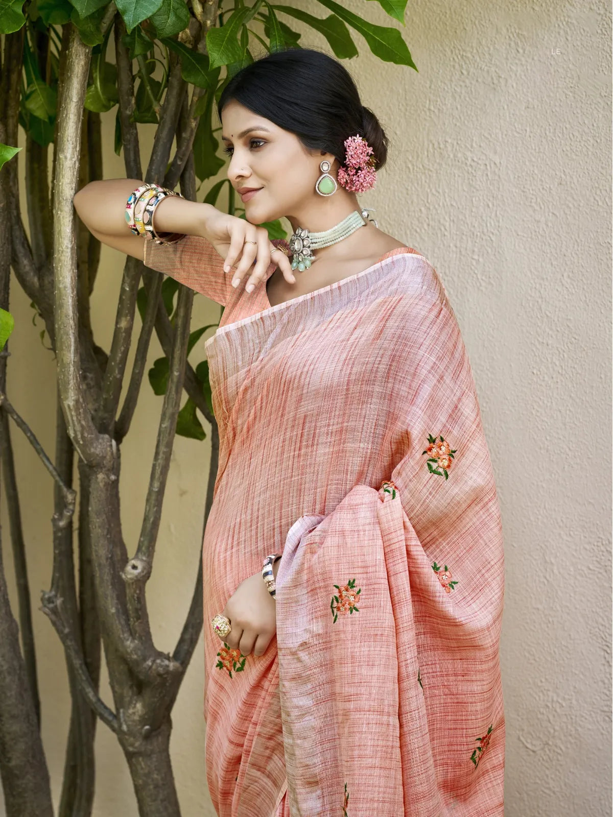 Tarani peach linen saree upper body view with embroidered motifs and blouse