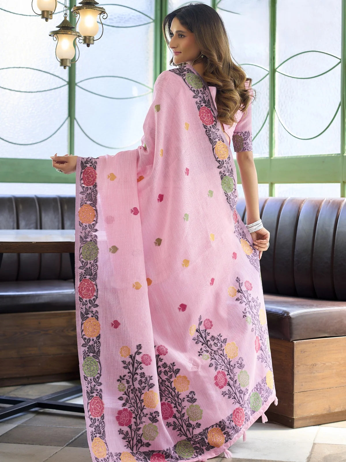Tarani pink linen handloom saree back view with floral woven pallu and elegant drape
