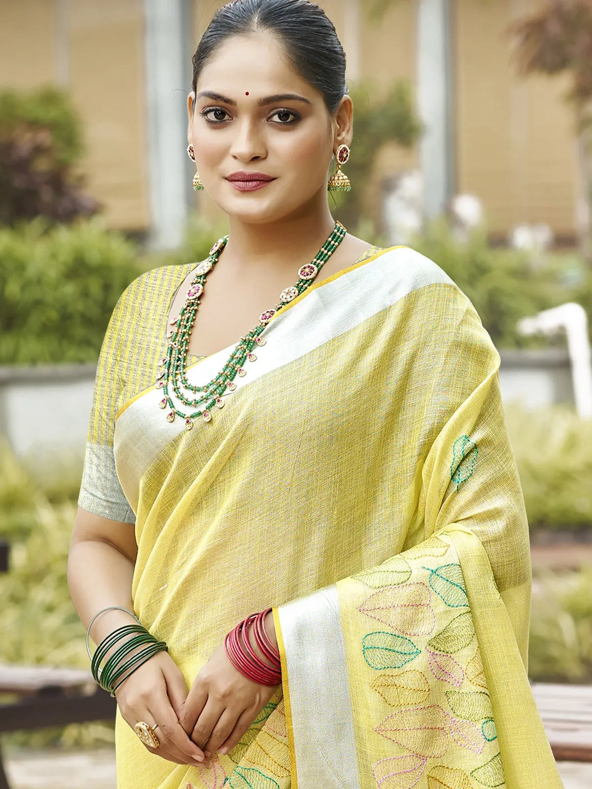 Tarani yellow linen saree upper body view styled with jewelry