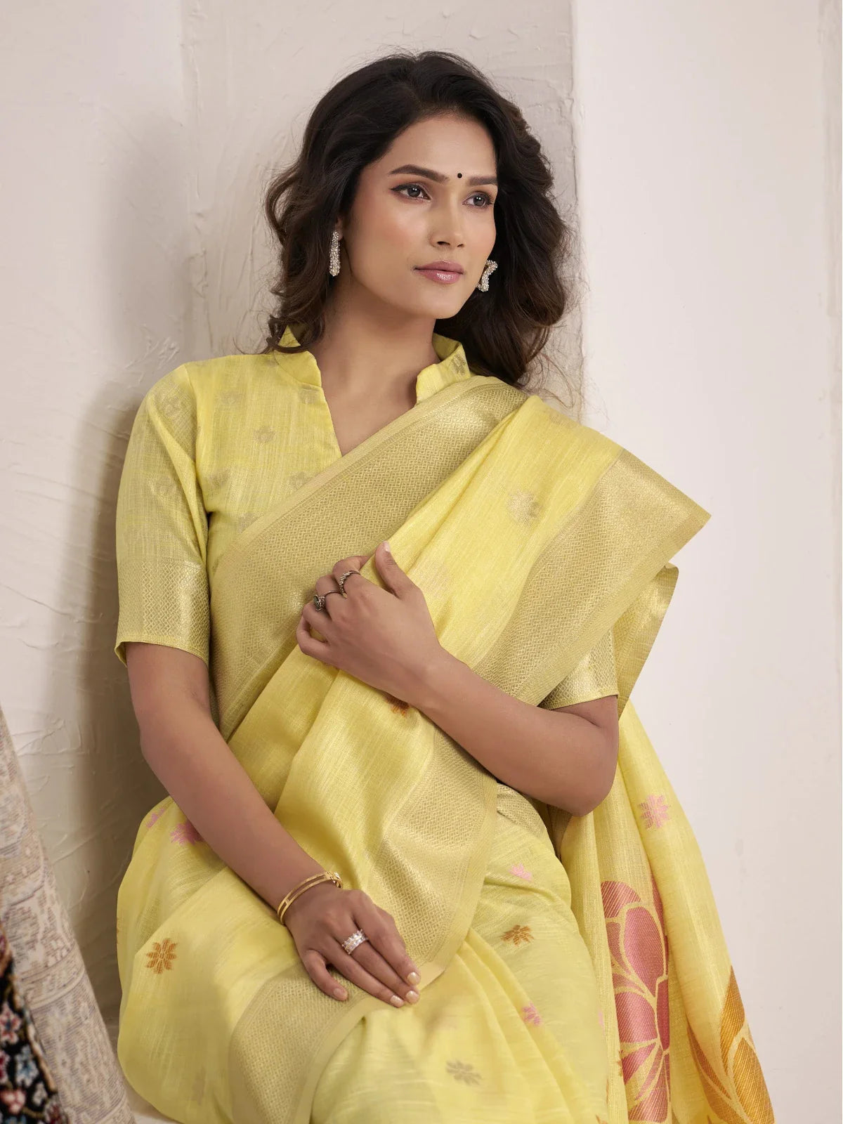 Tarani yellow linen saree upper body view showing fine butti work and subtle shine