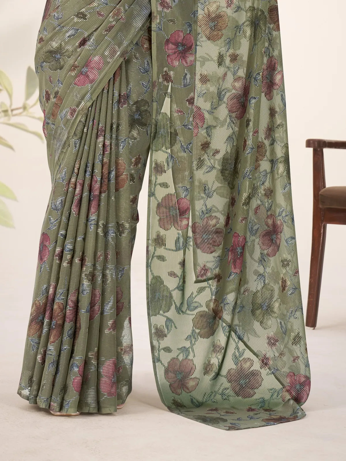 Tarani closeup of green lurex brasso saree showing multicolor floral detailing and shimmer texture