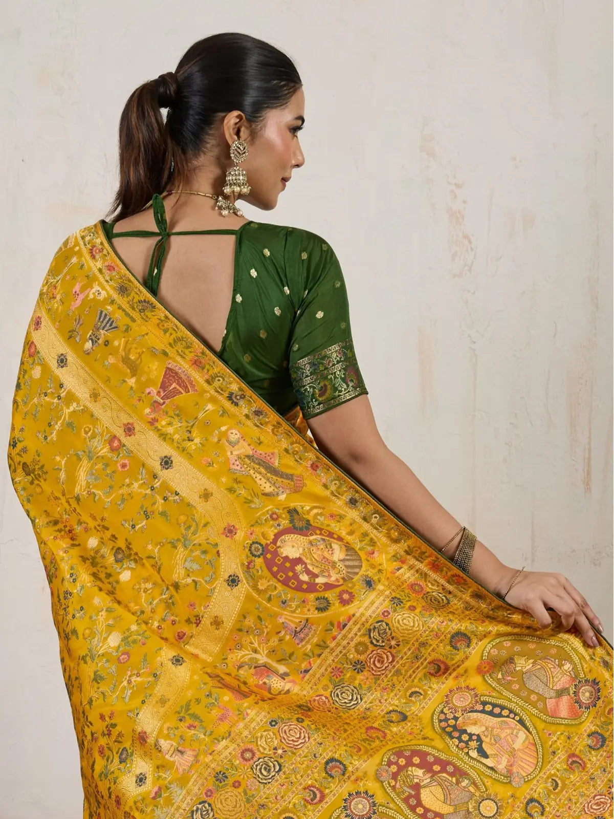 Tarani yellow silk saree elegant back view with stylish green blouse design