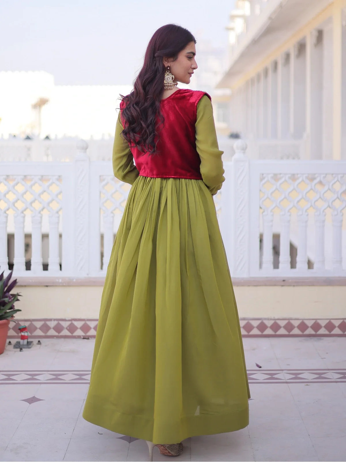 Back view of Tarani Mal Chanderi gown in green with embroidered red velvet jacket