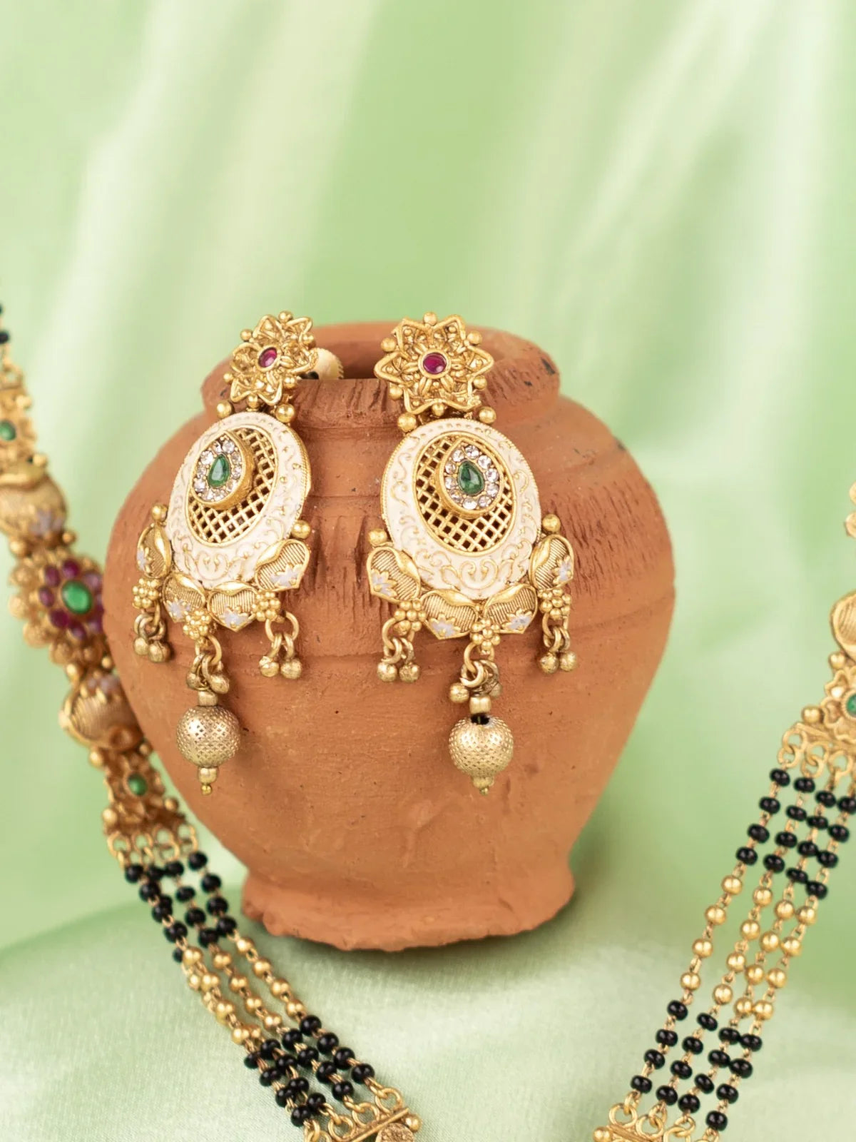 Tarani mangalsutra set view showing necklace and earrings crafted in gold plated finish for festive wear