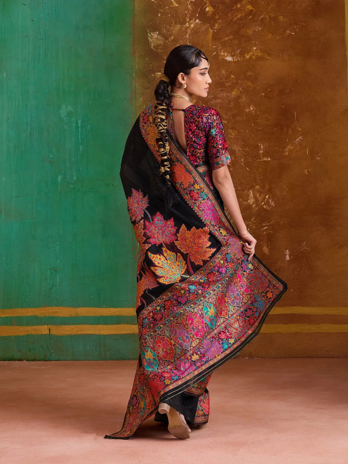 Tarani black saree back view highlighting detailed pallu and multicolor embroidery