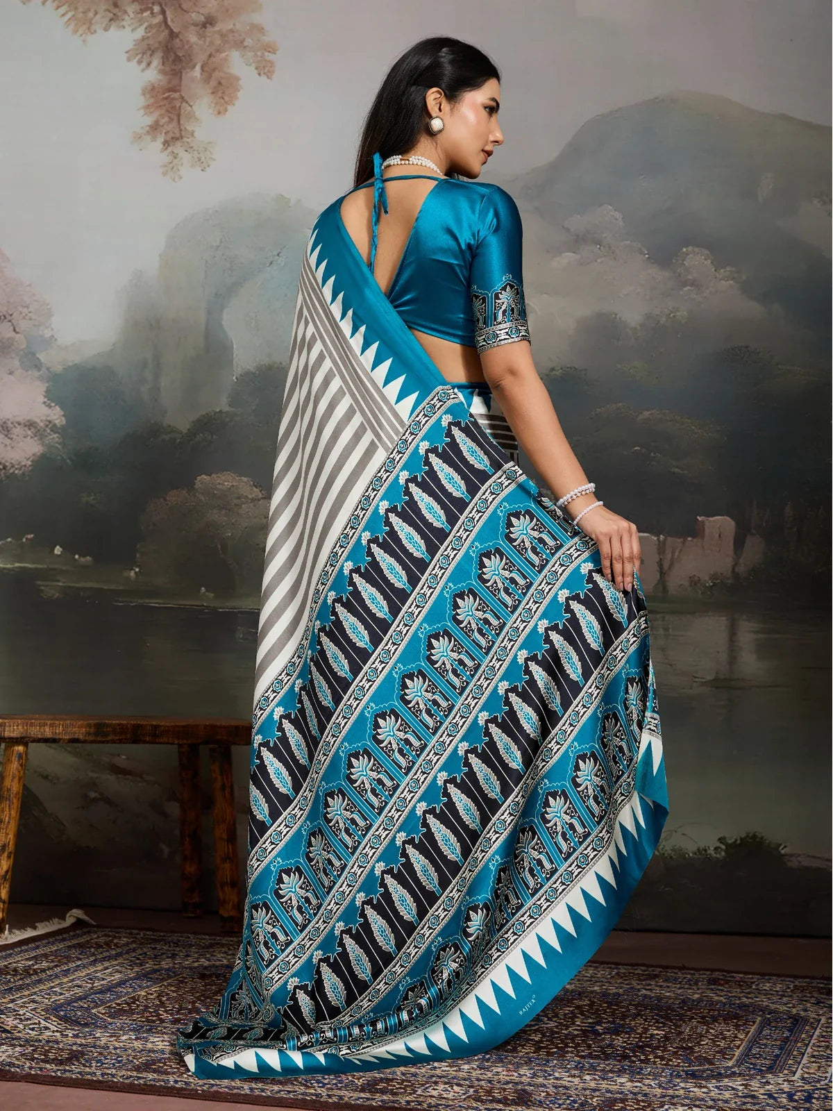 Tarani back view of blue ajrakh print saree with blouse design in modal satin fabric