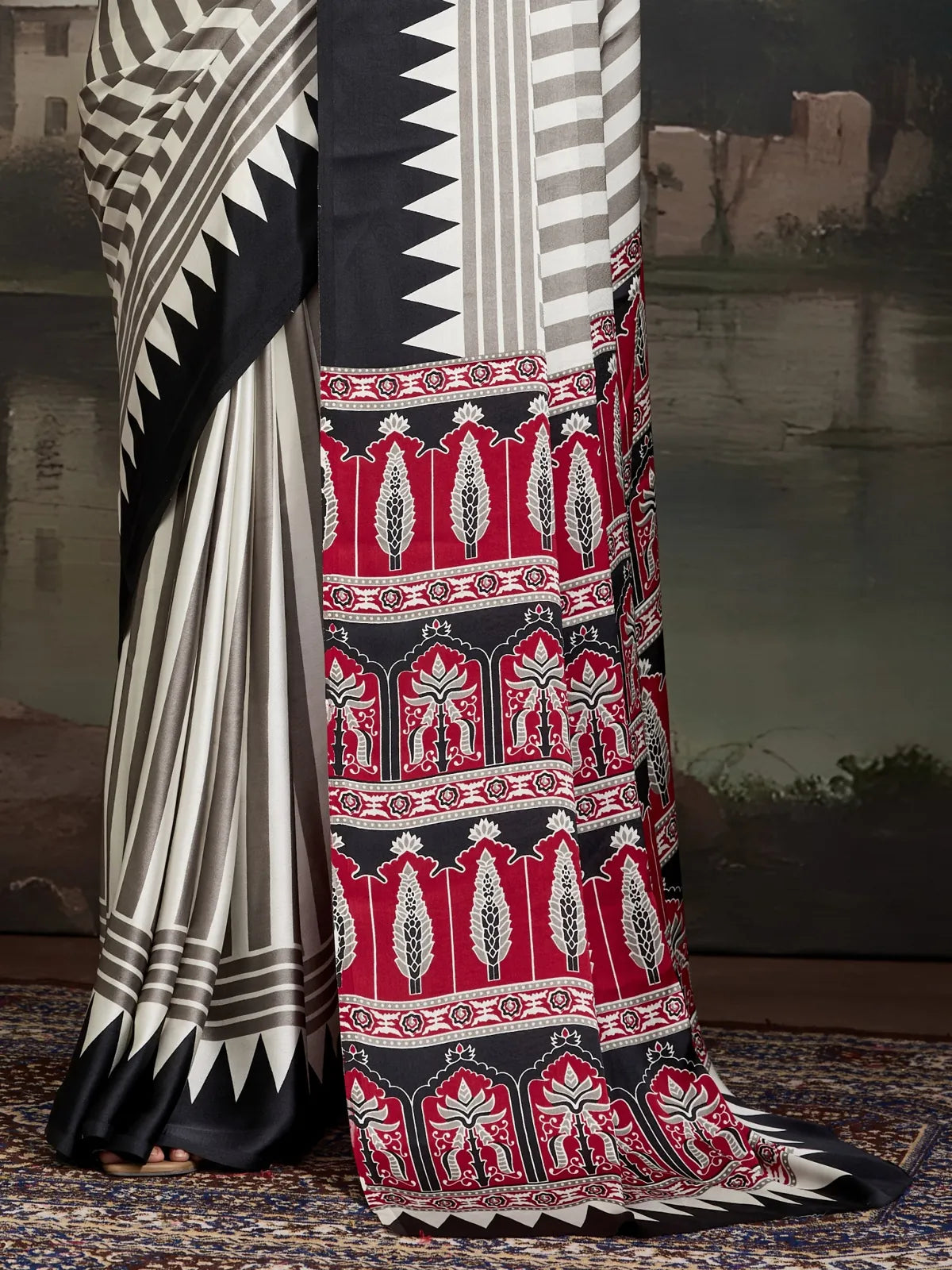 Close-up of Tarani saree pallu showcasing ajrakh red black border design with bold motifs