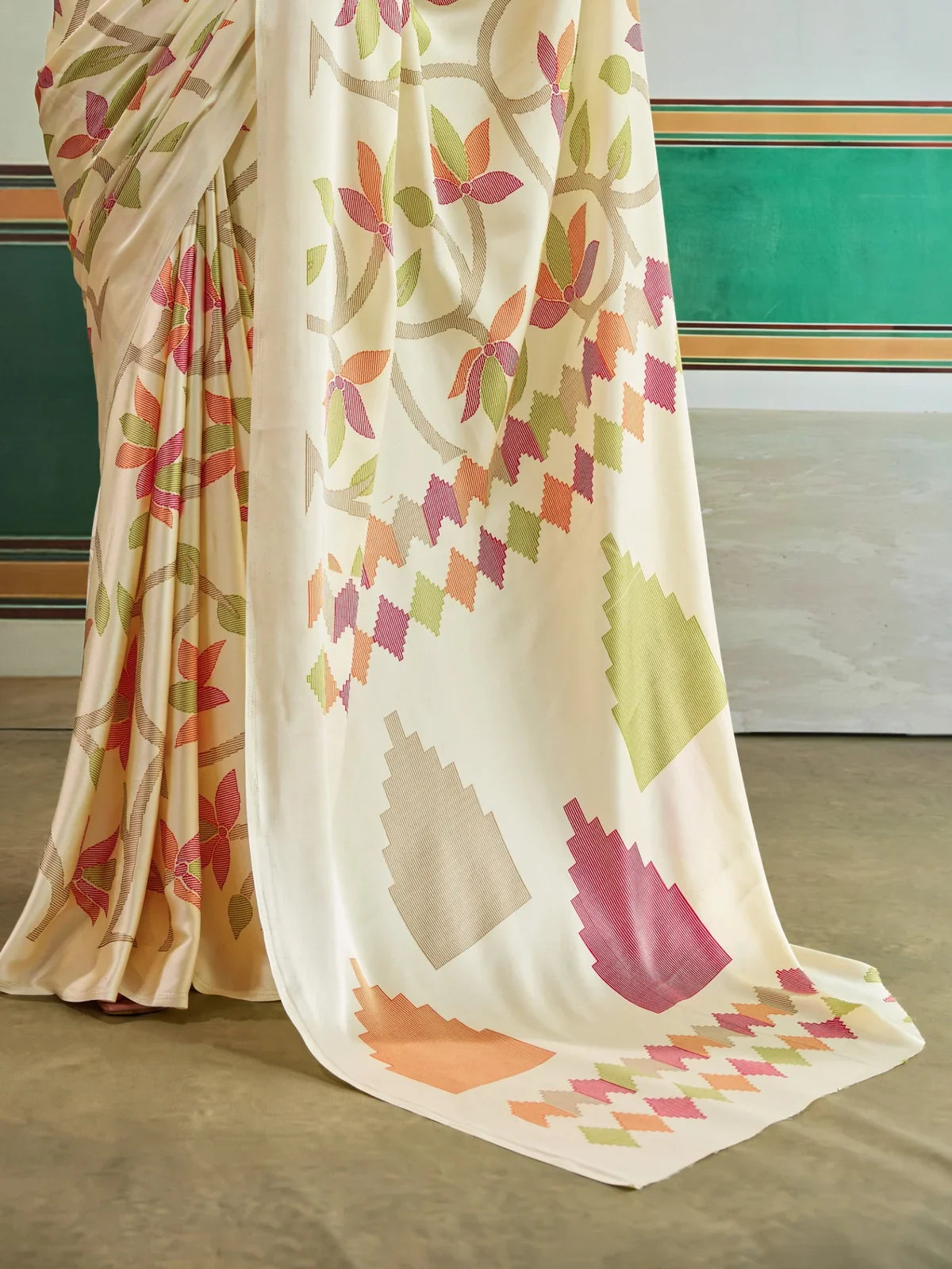 Tarani saree pallu view showing geometric triangles and floral vines in festive colors