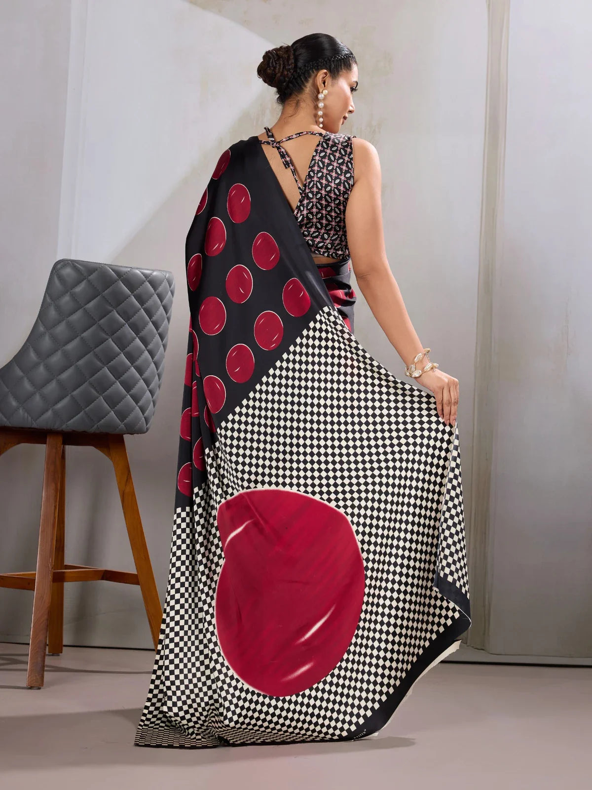 Tarani back view showing checkered pallu and criss-cross blouse design in modal satin saree