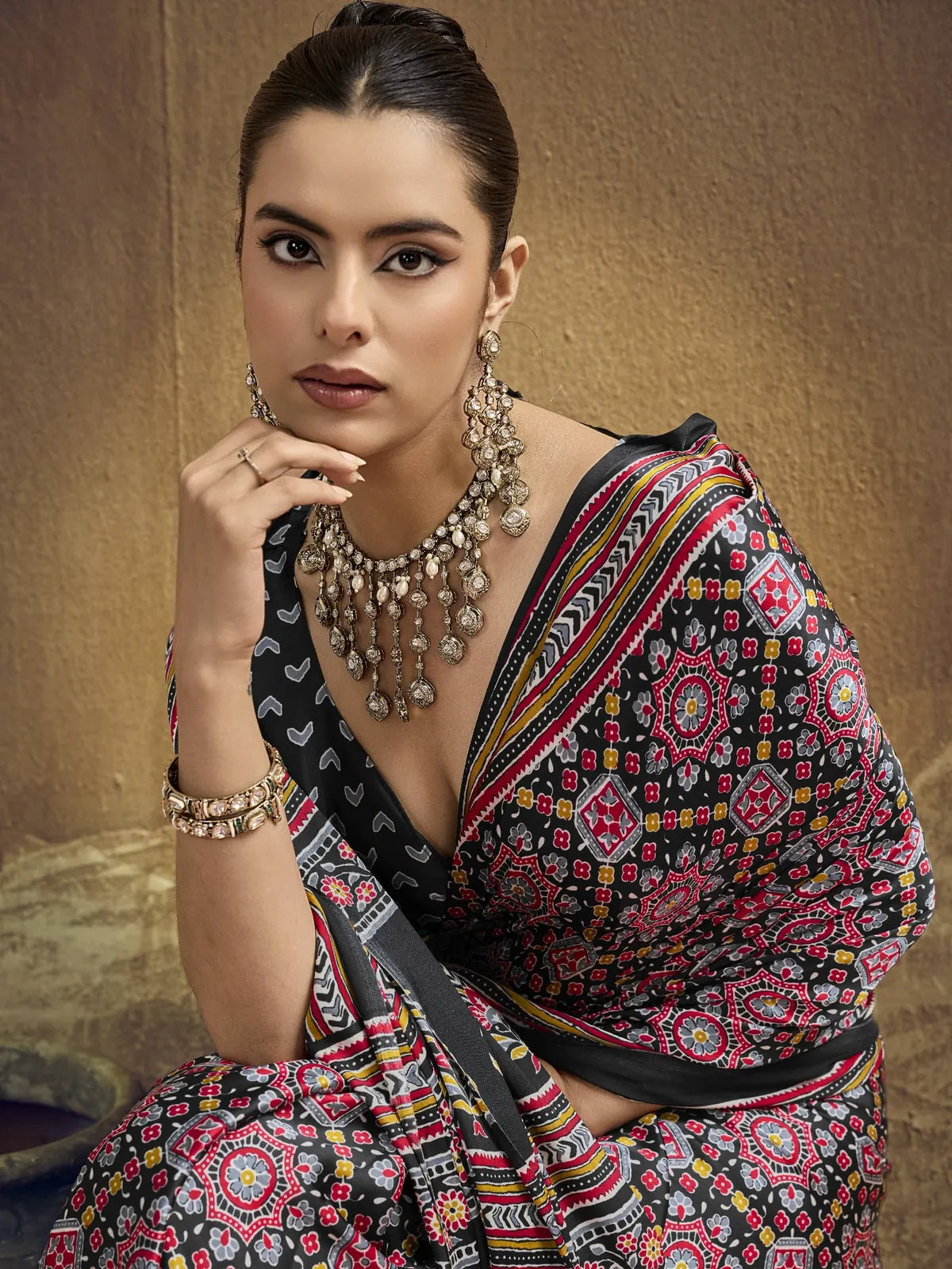Tarani black Ajrakh print saree closeup showcasing rich Modal Satin detailing