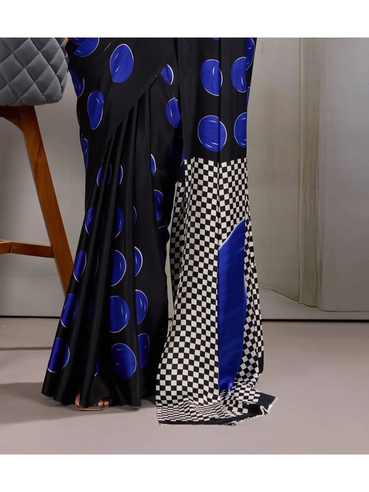 Tarani close-up view of saree detailing with blue circular patterns and silky texture