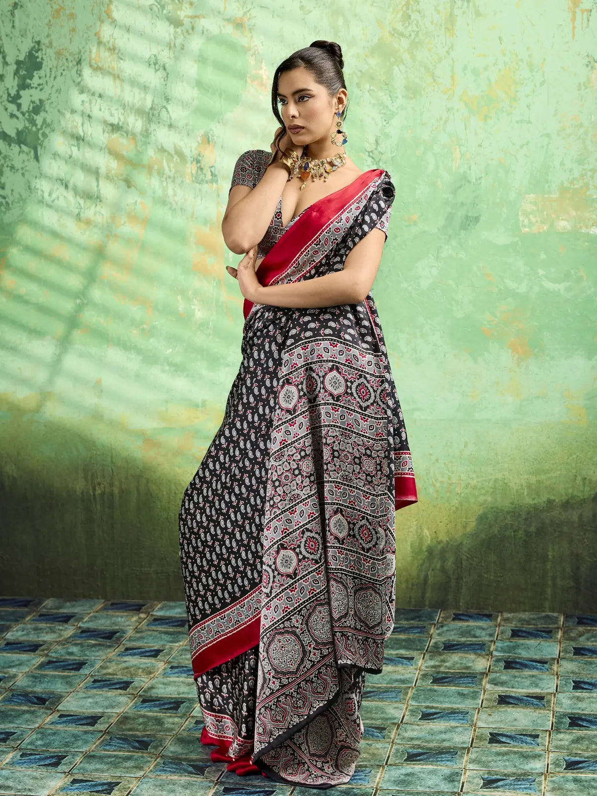 Tarani black Ajrakh print modal satin saree front pose with designer border and festive drape