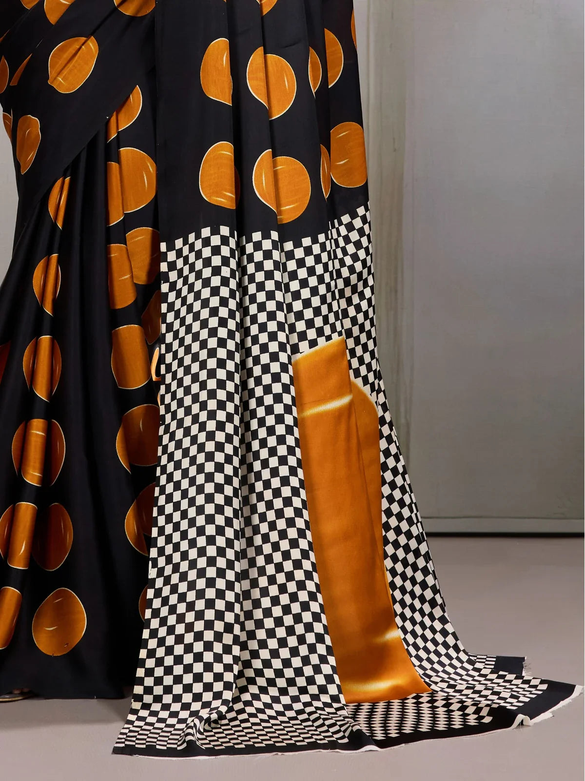 Tarani black saree pallu with golden patch and checkered pattern close-up view