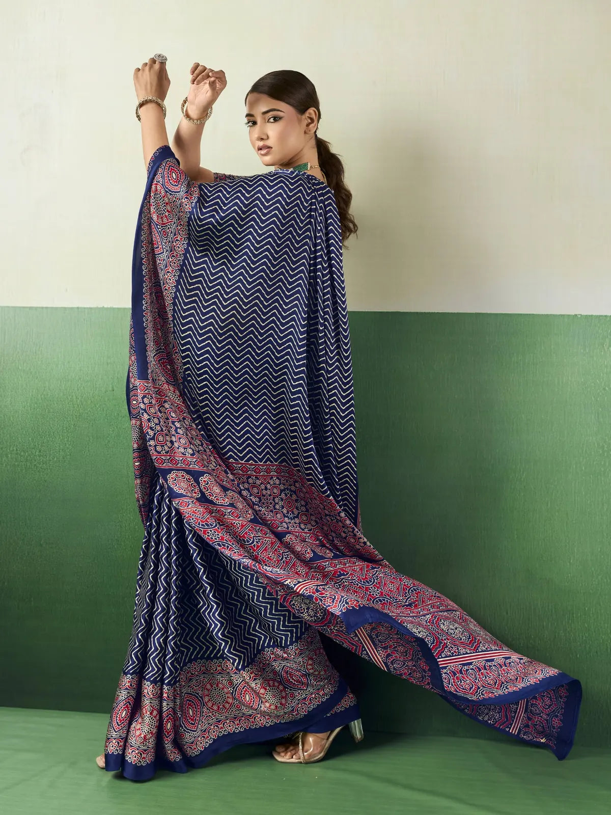 Tarani blue modal satin Ajrakh print saree back view with flowing pallu