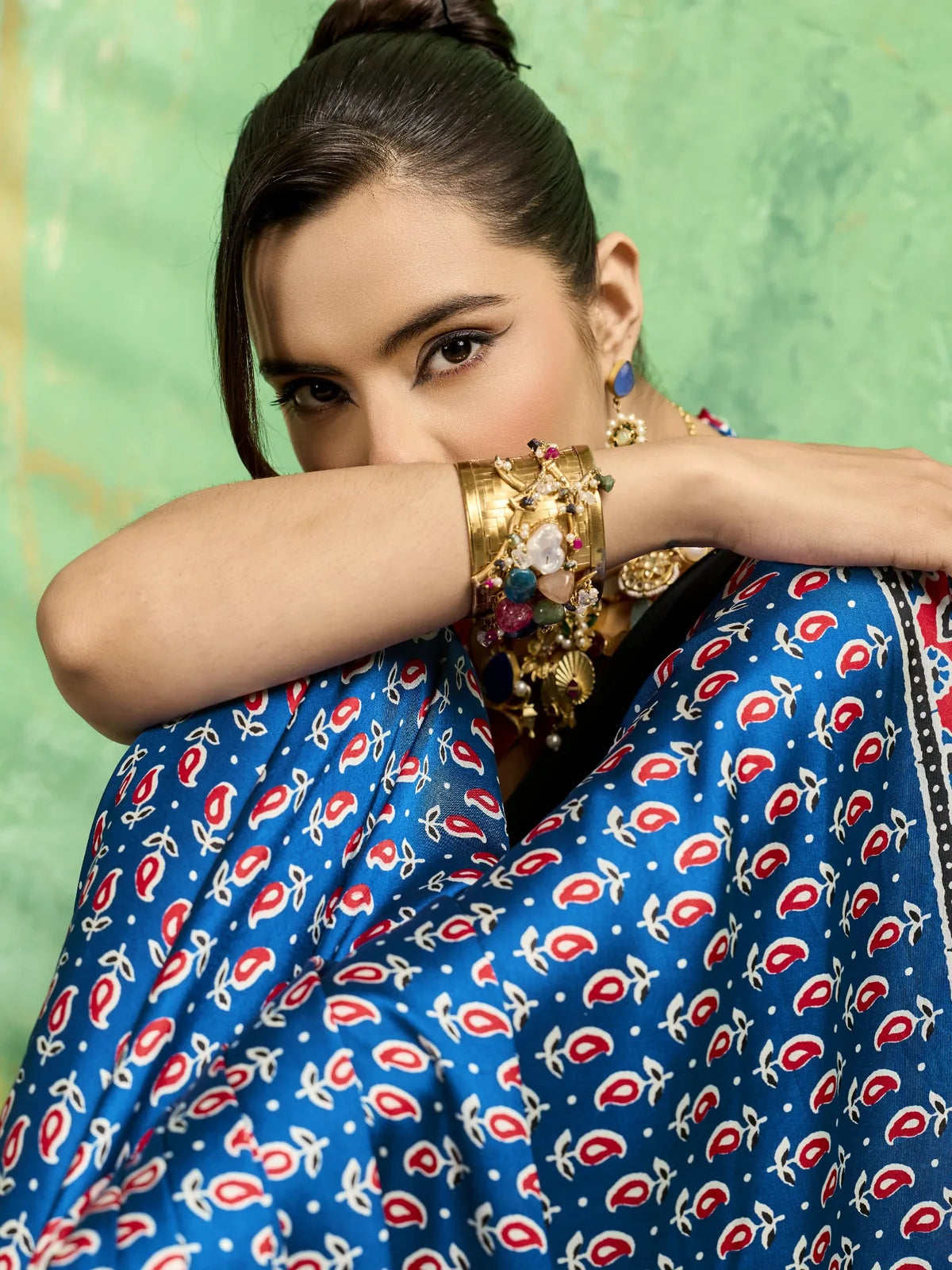 Tarani closeup view of blue modal satin Ajrakh print saree detailing and ethnic jewellery styling