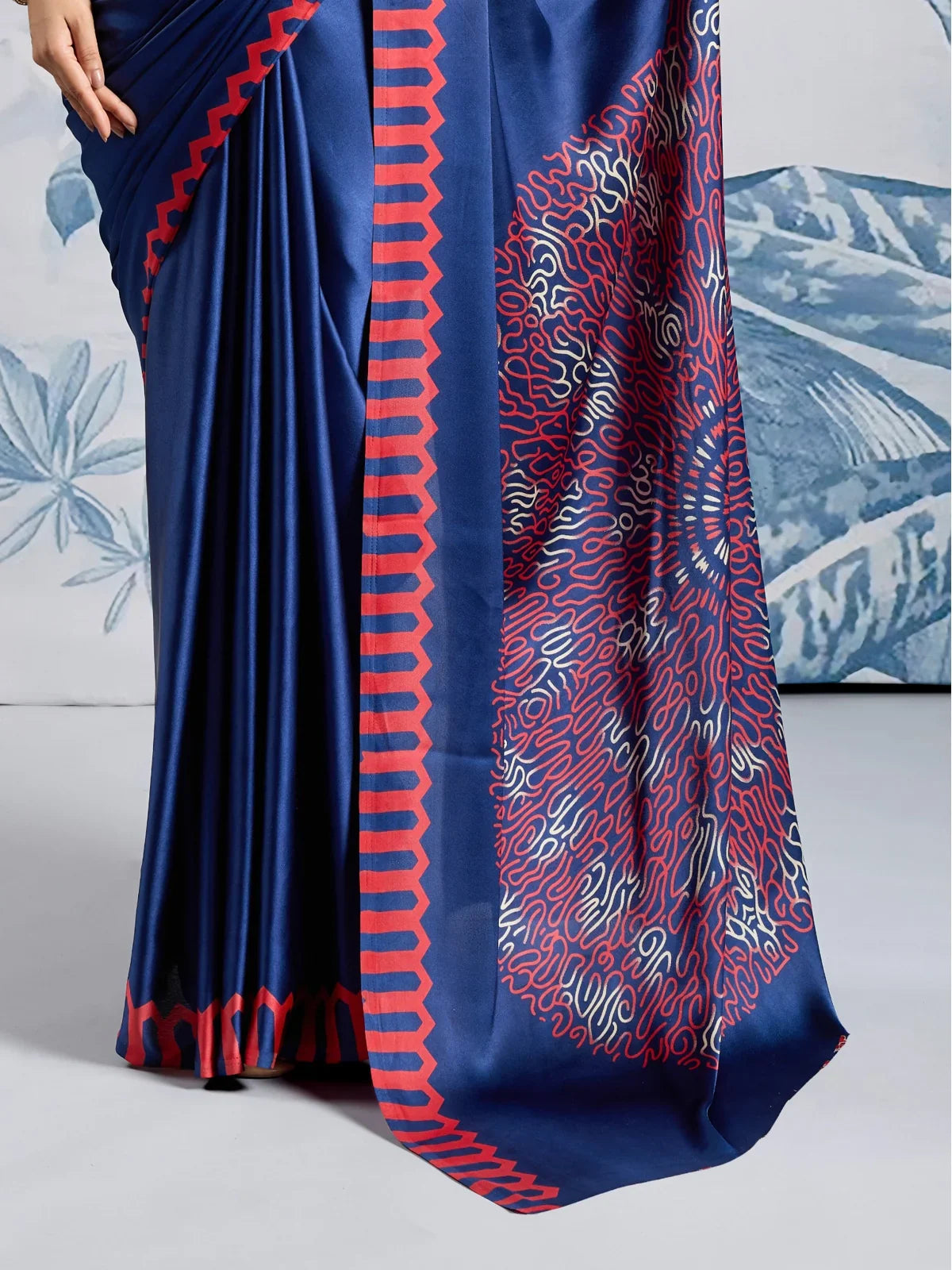 Tarani pallu and border design closeup of blue modal satin saree with circular ajrakh pattern