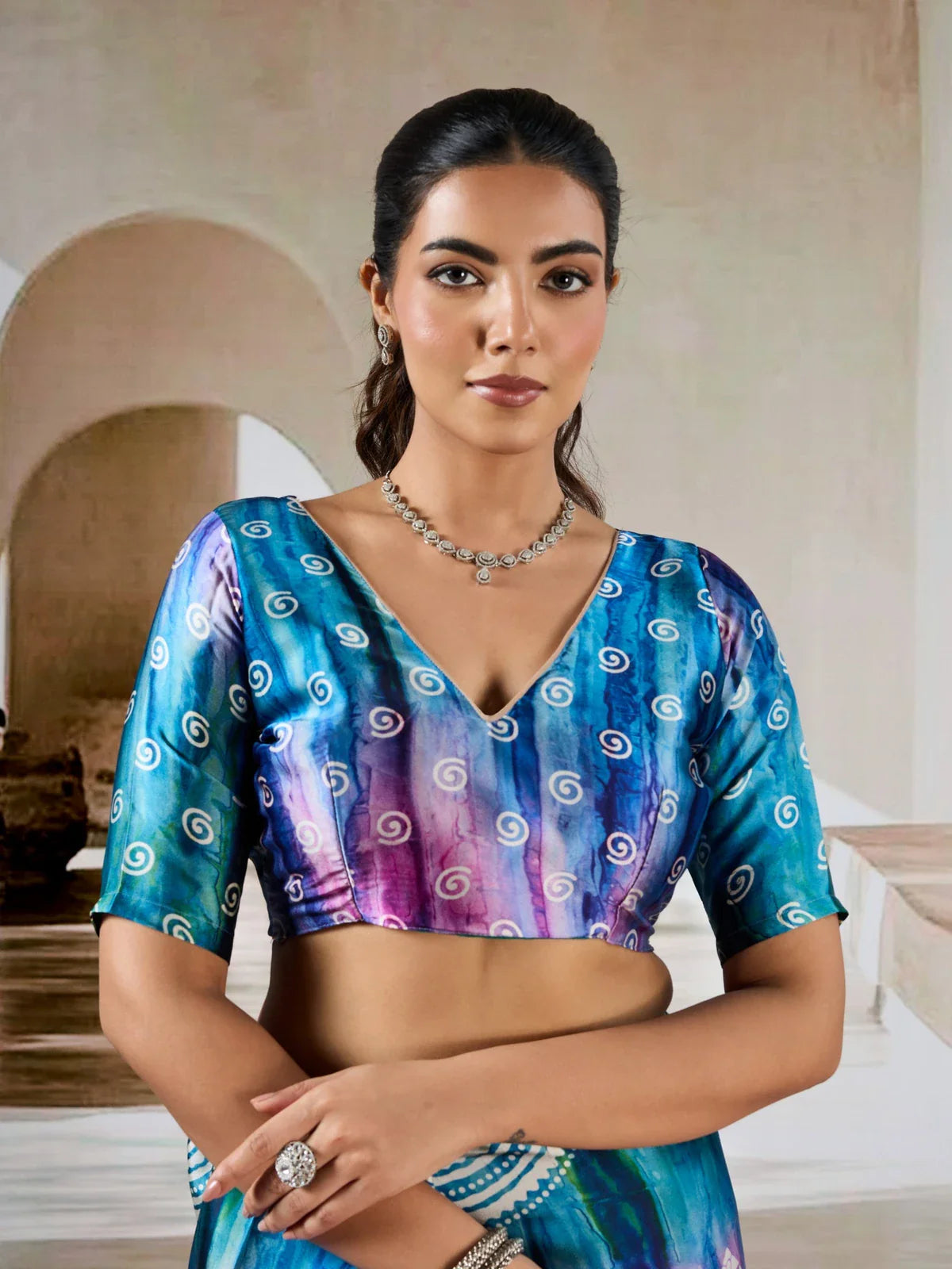 Tarani modal satin saree upper body closeup showing blouse and neckline with swirled print