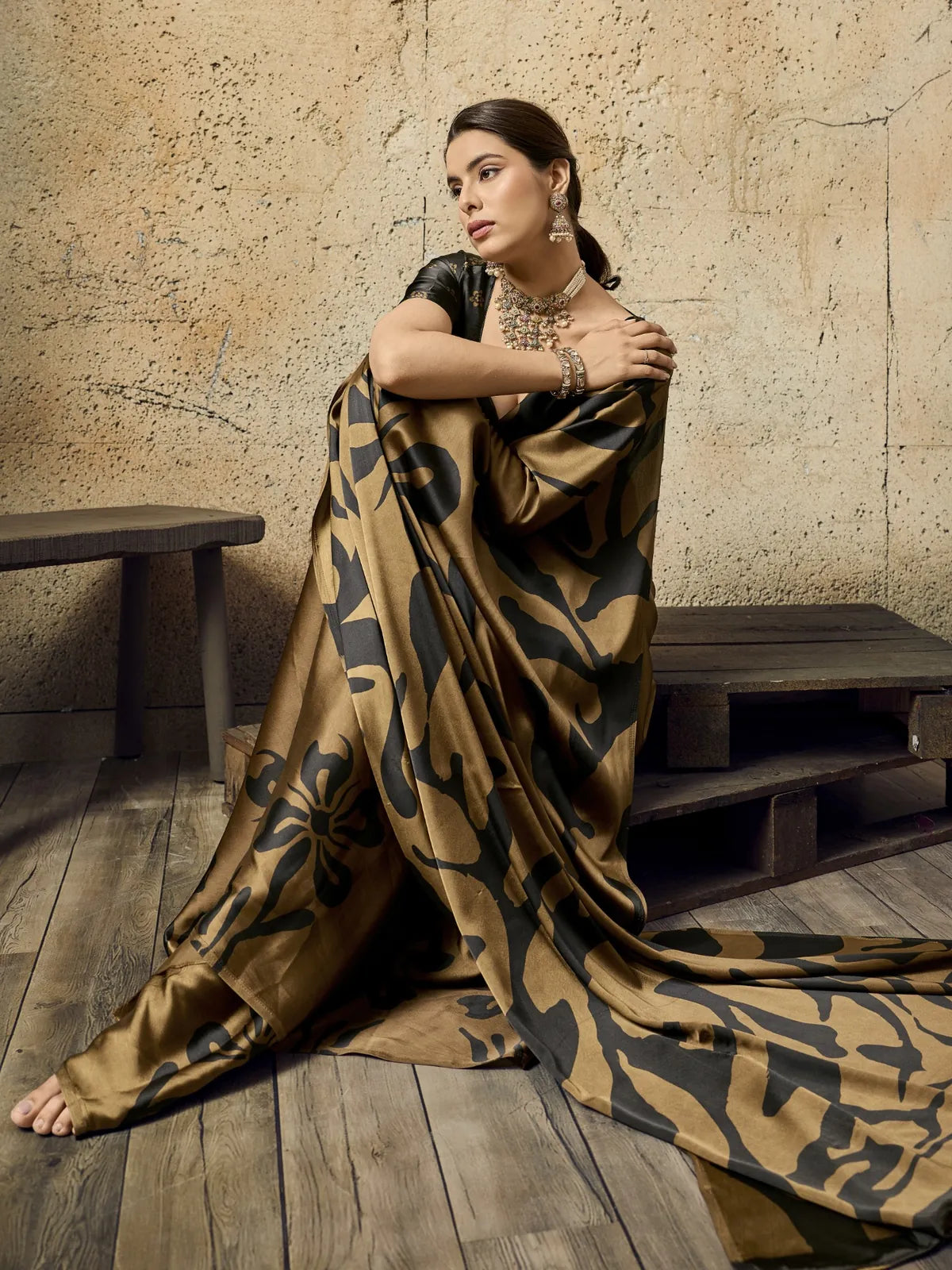 Tarani brown modal satin printed saree side pose showcasing flowing pallu and graceful drape styling